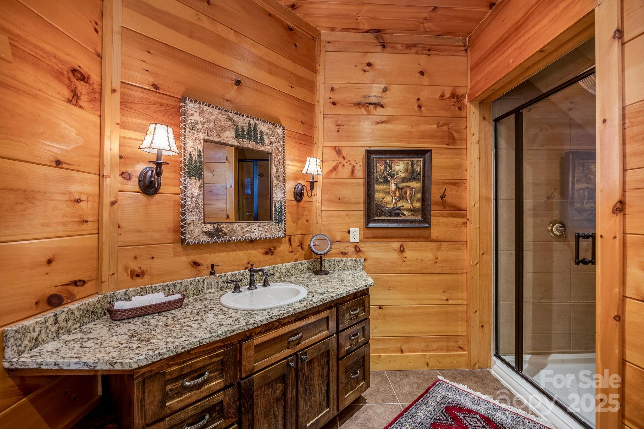 197 Smooth Rock Point Ridgeway, SC 29130 - Photo 31 of 48 a bathroom with a granite countertop sink and a mirror