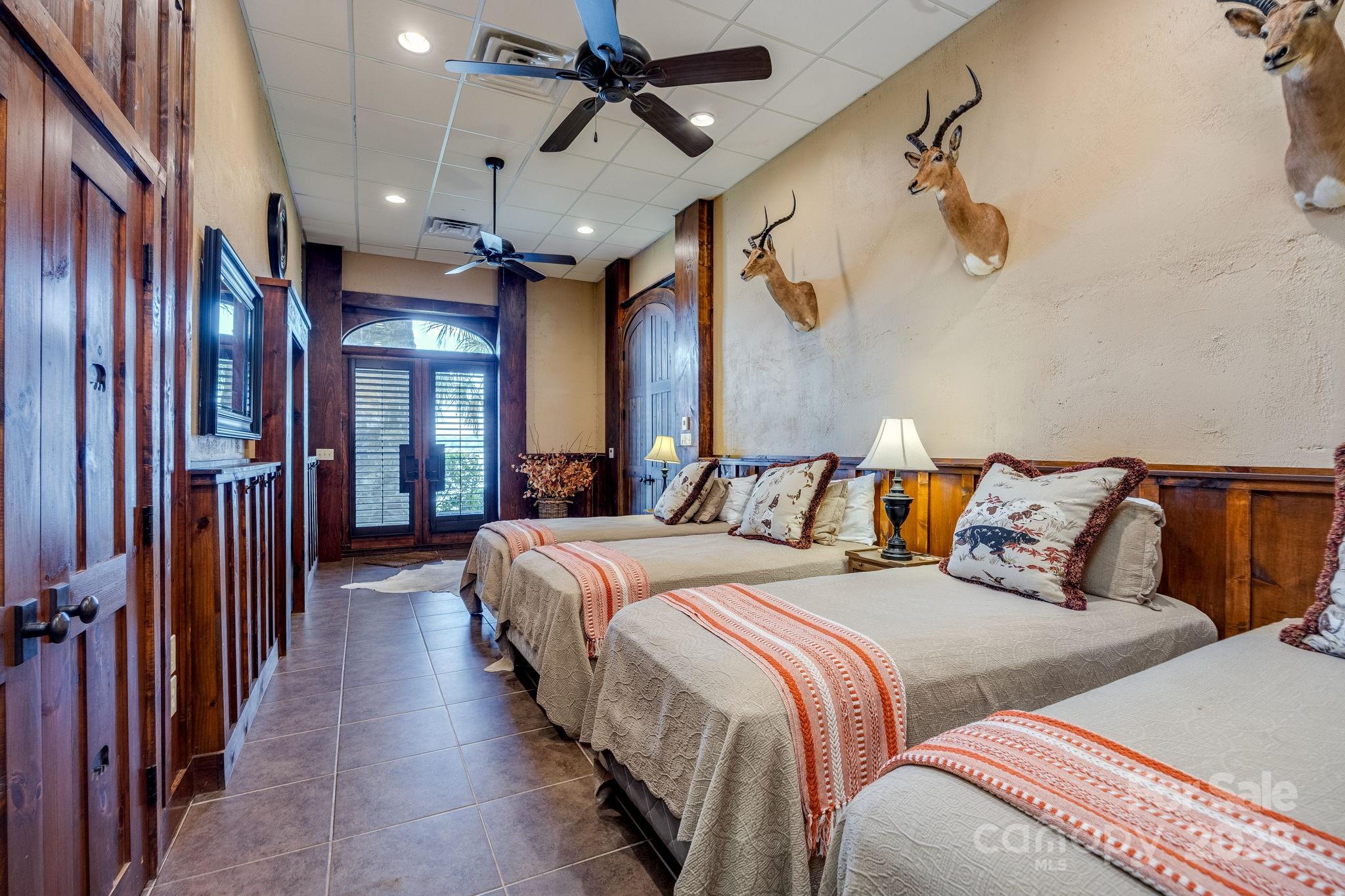 197 Smooth Rock Point Ridgeway, SC 29130 - Photo 34 of 48 a large bedroom with bed and a chandelier