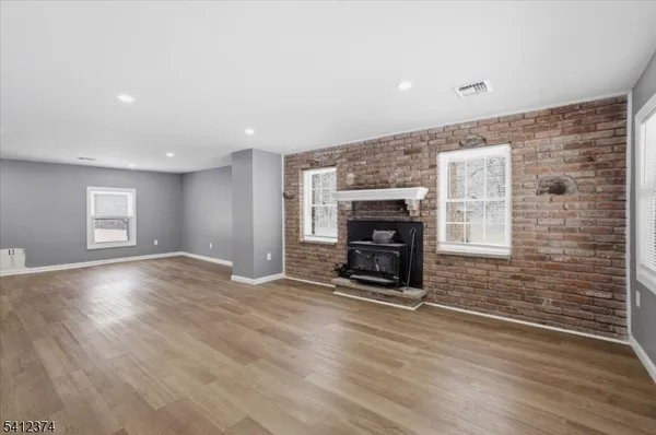 an empty room with fireplace and windows