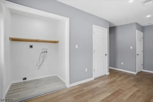 an empty room with wooden floor and closet