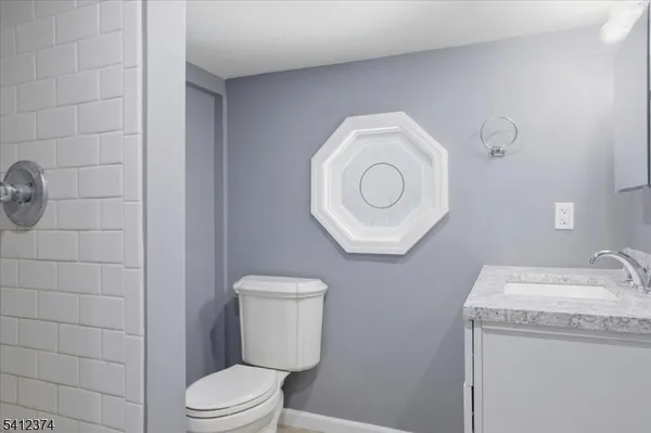 a white toilet sitting next to a bathroom sink