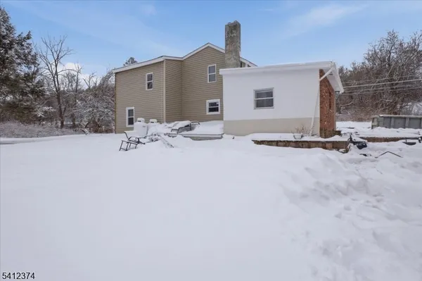a view of a house with snow on the road