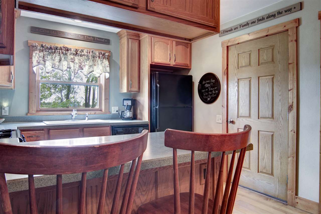 15232 Kelley Road Pecatonica, IL 61063 - Photo 11 of 24 a view of a dining room with furniture window and wooden floor