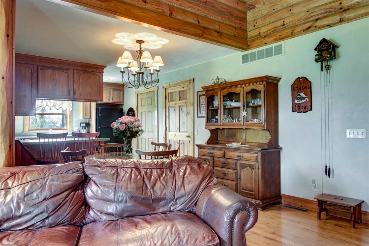 15232 Kelley Road Pecatonica, IL 61063 - Photo 13 of 24 a living room with furniture dining table and a chandelier