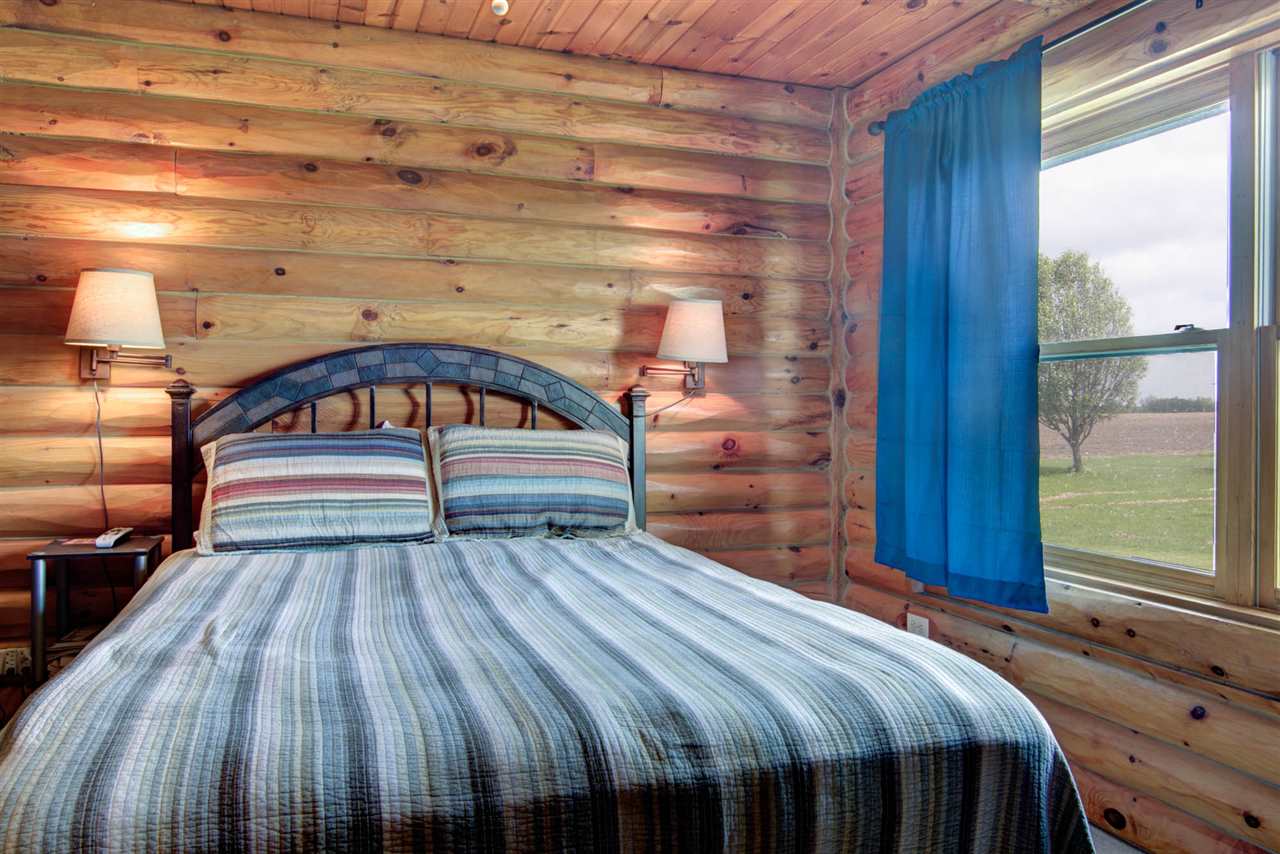 15232 Kelley Road Pecatonica, IL 61063 - Photo 17 of 24 a bedroom with a bed and wooden floor