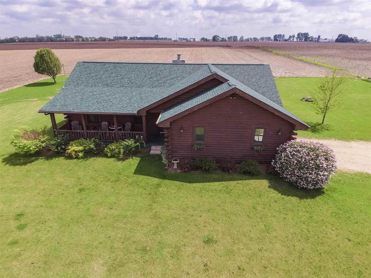 15232 Kelley Road Pecatonica, IL 61063 - Photo 2 of 24 a view of a house with a yard and a pond