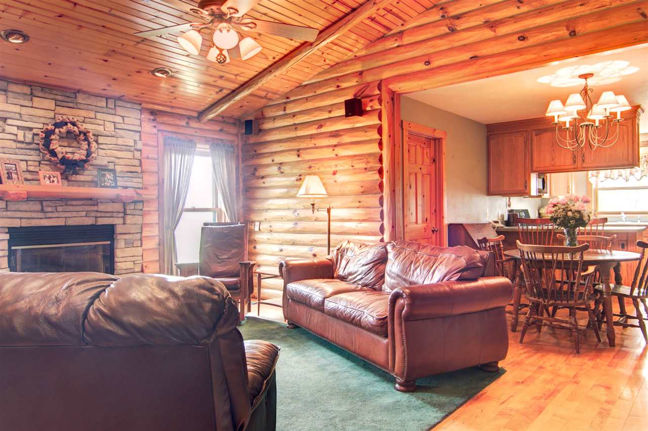 15232 Kelley Road Pecatonica, IL 61063 - Photo 5 of 24 a living room with furniture a large window and a fireplace