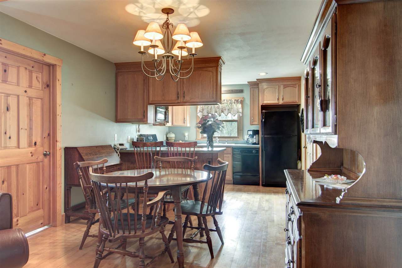 15232 Kelley Road Pecatonica, IL 61063 - Photo 10 of 24 a dining room with furniture a chandelier and wooden floor