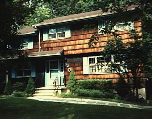 53 Langstroth Drive Ridgefield, CT 06877 - Photo 1 of 1 a front view of a house with a yard