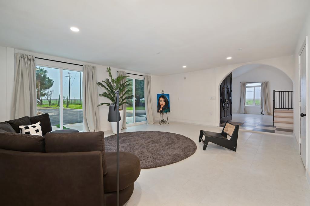 7011 Kemper Road Oakdale, CA 95361 - Photo 11 of 50 a living room with furniture potted plant and a large window