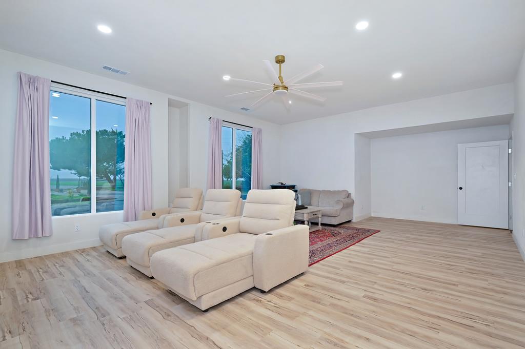 7011 Kemper Road Oakdale, CA 95361 - Photo 14 of 50 a spacious bedroom with a large bed and a large window