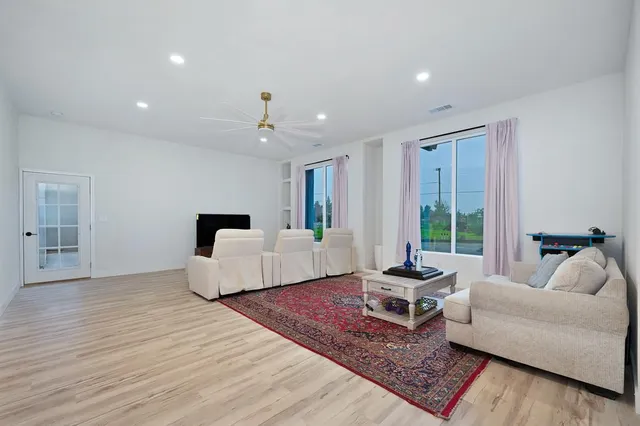 a large kitchen with a table chairs and a chandelier