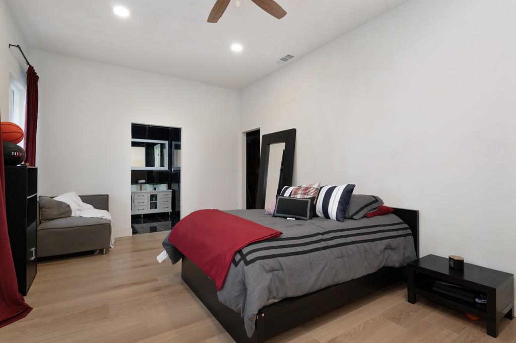 7011 Kemper Road Oakdale, CA 95361 - Photo 18 of 50 a bedroom with a bed and a couch