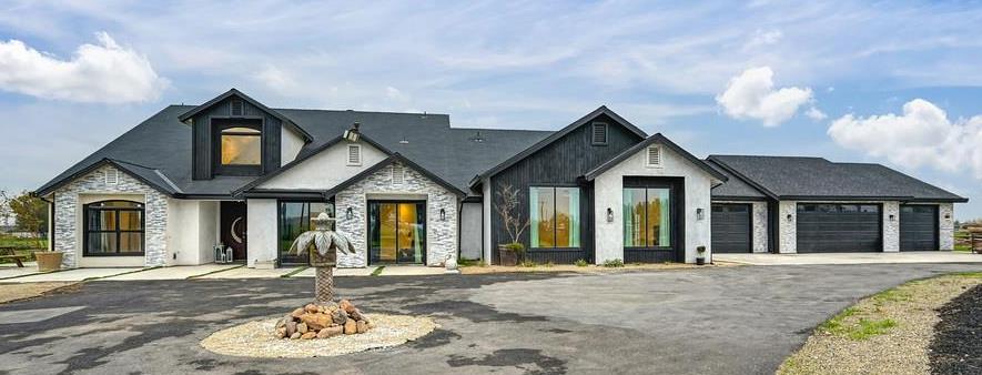 7011 Kemper Road Oakdale, CA 95361 - Photo 2 of 50 a front view of a house with a yard and garage
