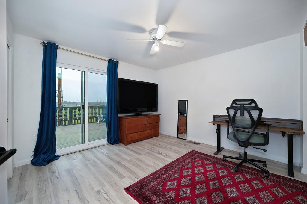 7011 Kemper Road Oakdale, CA 95361 - Photo 25 of 50 a bedroom with furniture and a flat screen tv