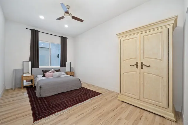 a bedroom with furniture and a flat screen tv