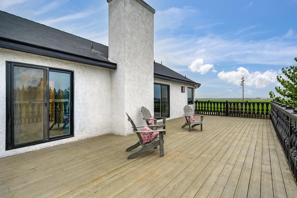 7011 Kemper Road Oakdale, CA 95361 - Photo 34 of 50 a view of a roof deck with chair and wooden floor