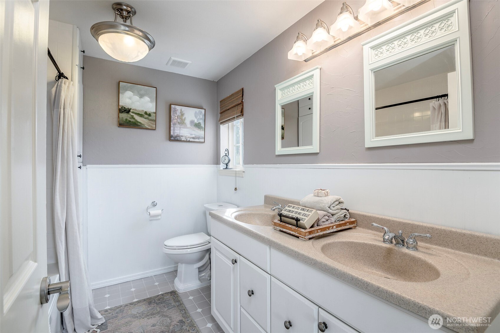 1310 Sequalish Street Steilacoom, WA 98388 - Photo 20 of 30 a bathroom with a granite countertop toilet sink and mirror