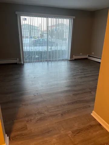 a view of wooden floor and windows in a room