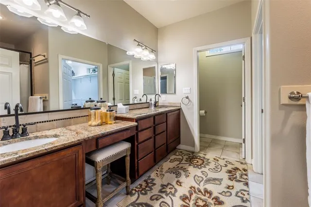 a bathroom with a sink a toilet and mirror