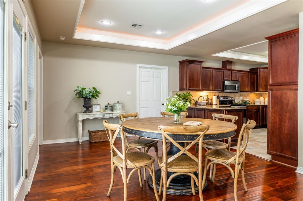 608 East 13th Street Georgetown, TX 78626 - Photo 9 of 22 a dining room with furniture and wooden floor