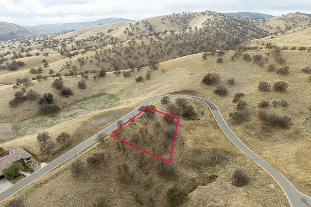 a view of a dry yard with mountains
