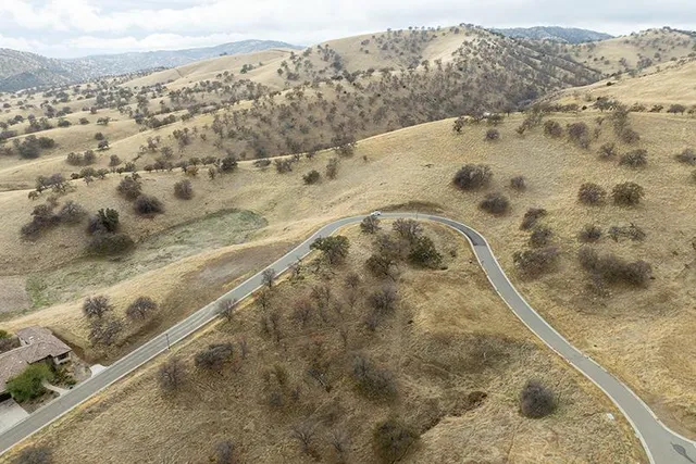 a view of swimming pool with a yard and mountain view
