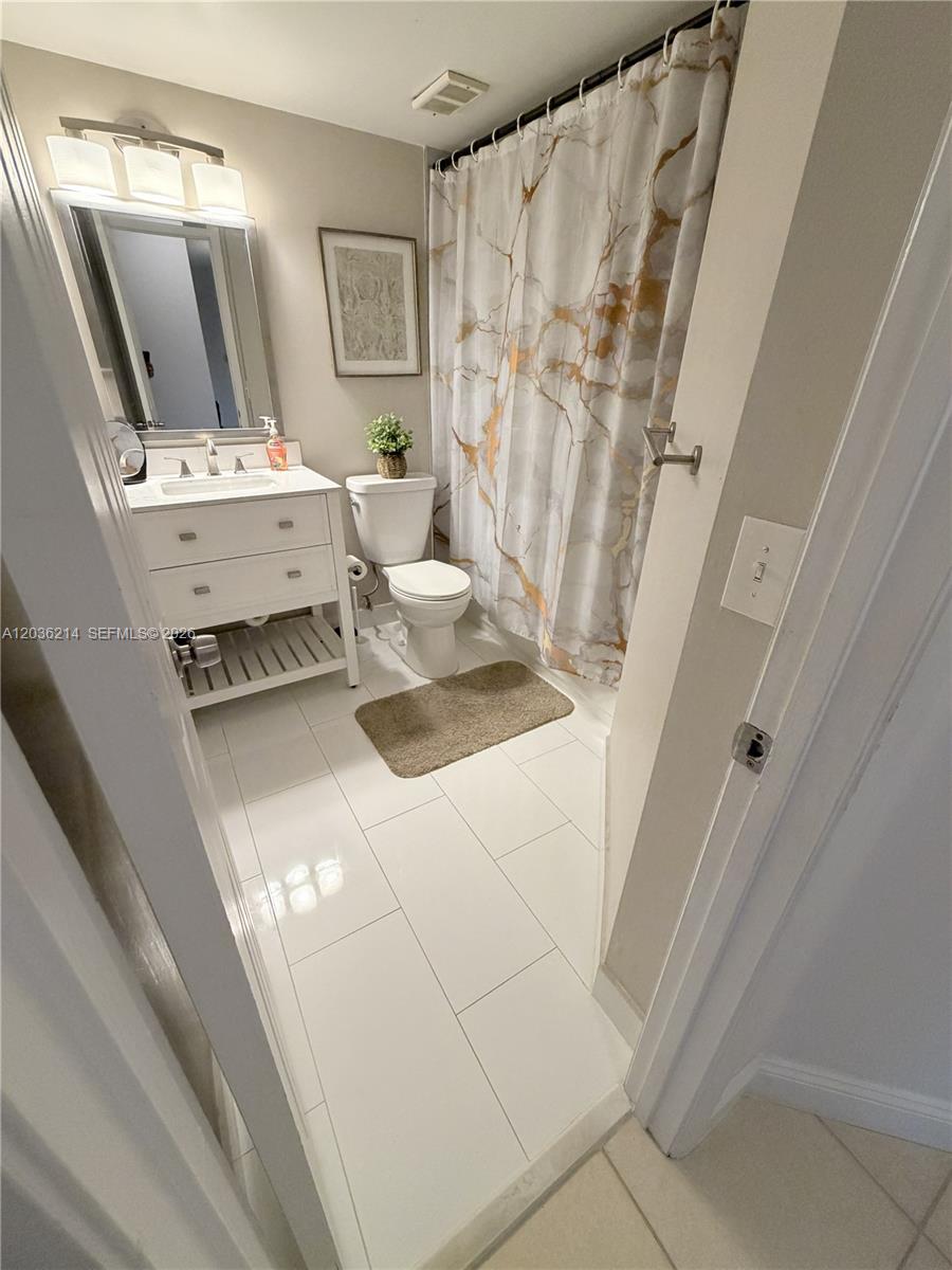 8741 Wiles Road, Unit 204 Coral Springs, FL 33067 - Photo 8 of 16 a bathroom with a sink a toilet and shower
