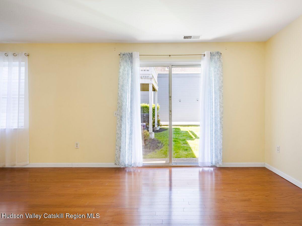 902 Commons Way, Unit B Fishkill, NY 12524 - Photo 12 of 24 a view of an empty room with wooden floor and a window