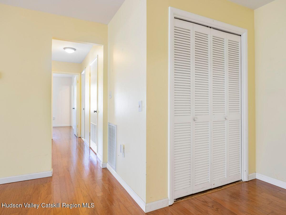 902 Commons Way, Unit B Fishkill, NY 12524 - Photo 15 of 24 a view of a hallway with wooden floor