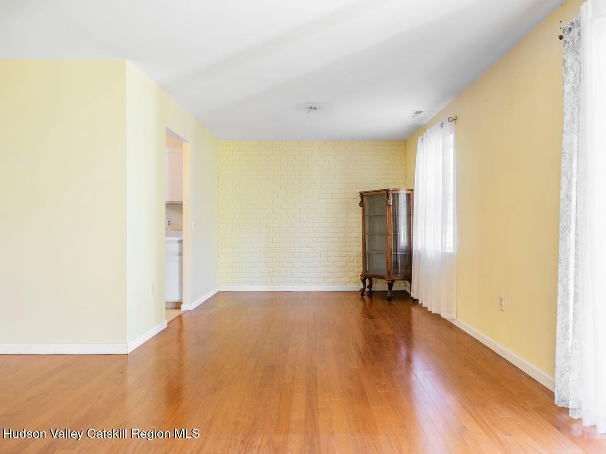902 Commons Way, Unit B Fishkill, NY 12524 - Photo 16 of 24 a view of an empty room with wooden floor