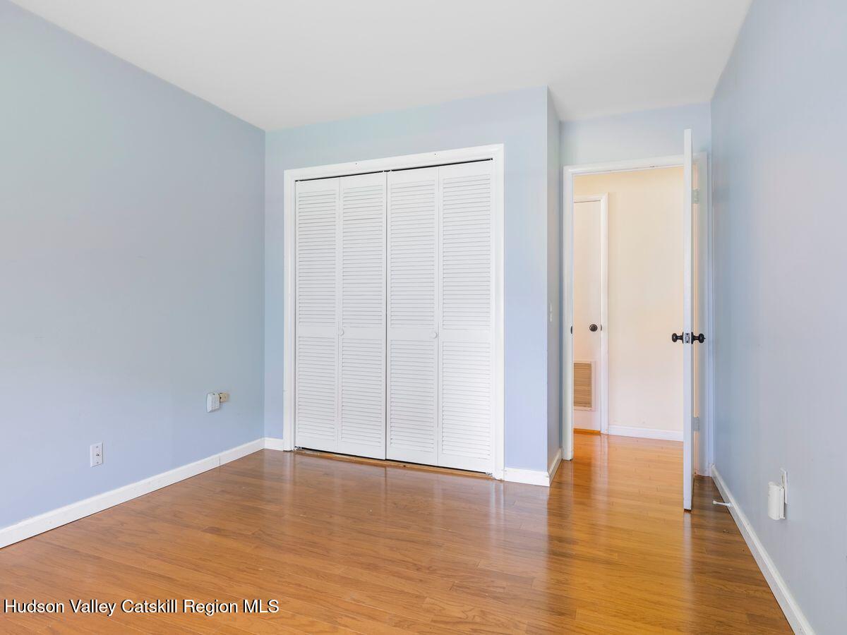 902 Commons Way, Unit B Fishkill, NY 12524 - Photo 18 of 24 a view of empty room with wooden floor