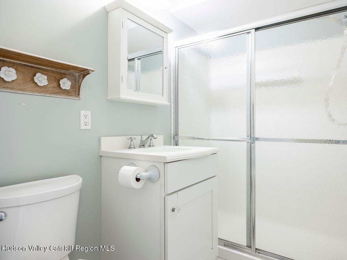 902 Commons Way, Unit B Fishkill, NY 12524 - Photo 19 of 24 a bathroom with a sink a toilet and shower