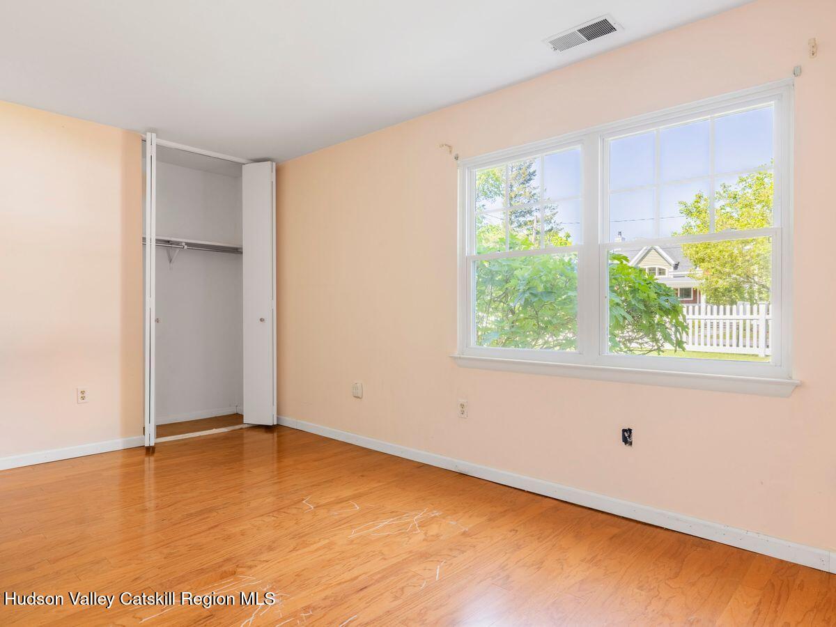 902 Commons Way, Unit B Fishkill, NY 12524 - Photo 21 of 24 a view of an empty room with wooden floor and a window