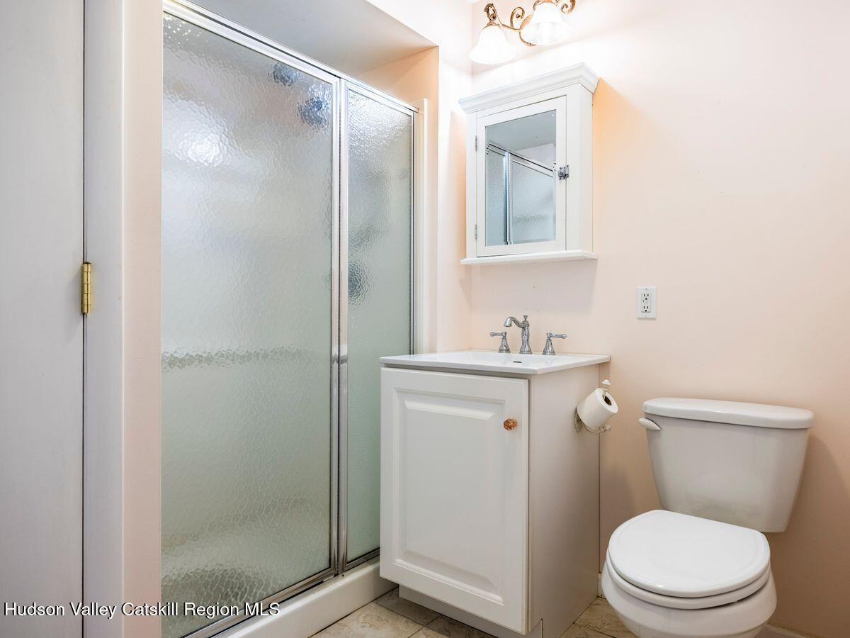 902 Commons Way, Unit B Fishkill, NY 12524 - Photo 24 of 24 a bathroom with a granite countertop sink toilet and shower