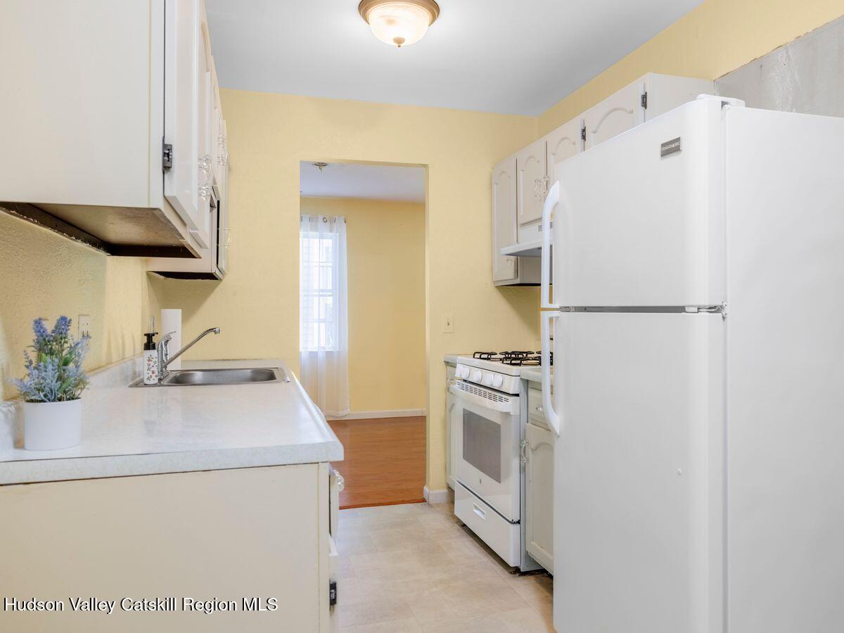 902 Commons Way, Unit B Fishkill, NY 12524 - Photo 6 of 24 a kitchen with a sink a stove and refrigerator