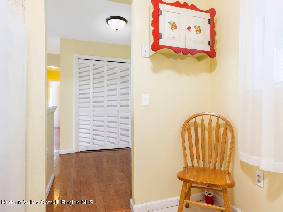 902 Commons Way, Unit B Fishkill, NY 12524 - Photo 9 of 24 a view of a hallway with wooden floor and a dining table