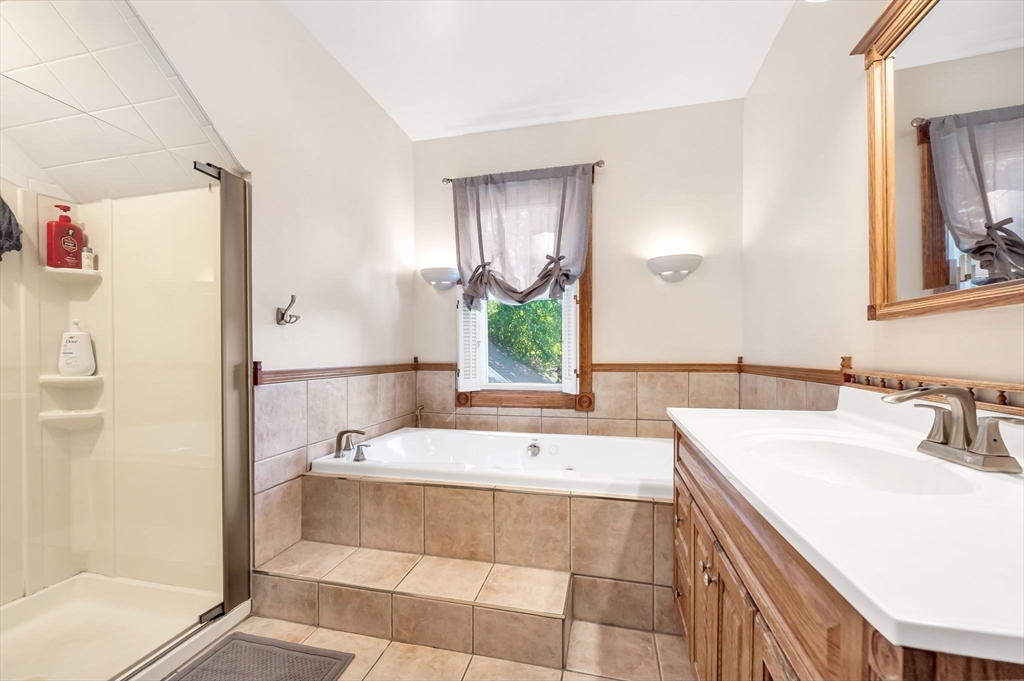 27 Powell Avenue Springfield, MA 01118 - Photo 23 of 34 a bathroom with a tub sink and mirror