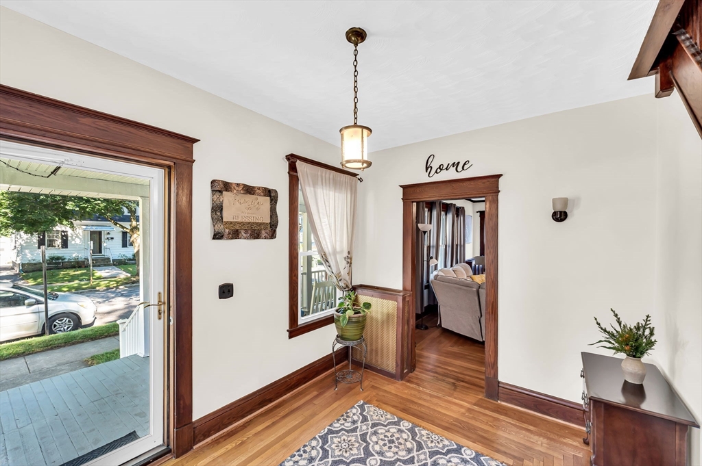 27 Powell Avenue Springfield, MA 01118 - Photo 5 of 34 a dining room with furniture wooden floor a chandelier
