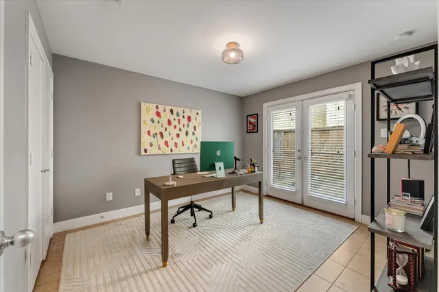 a view of a workspace with furniture and a window