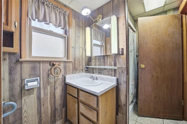 a bathroom with a sink vanity and a mirror