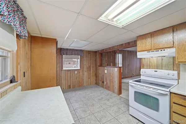 a kitchen with stainless steel appliances granite countertop a stove a refrigerator and a cabinets