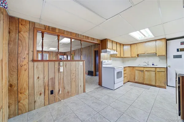 a kitchen with a refrigerator sink and cabinets
