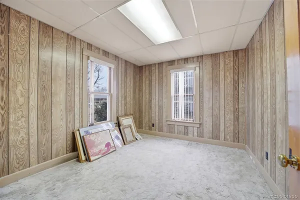 a living room with furniture and large windows