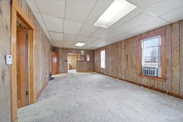 a view of a hallway with wooden shelves