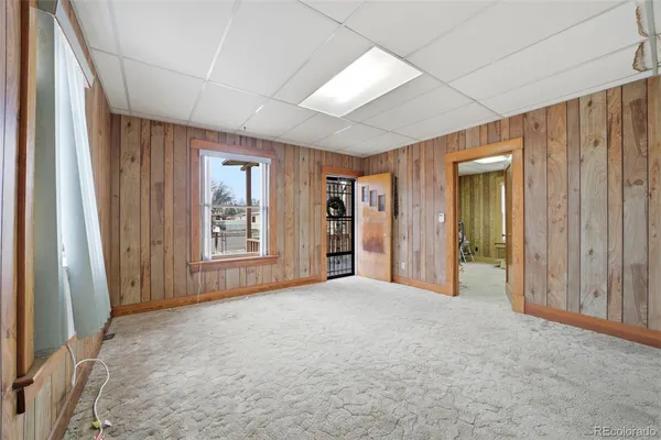 an empty room with windows and closet