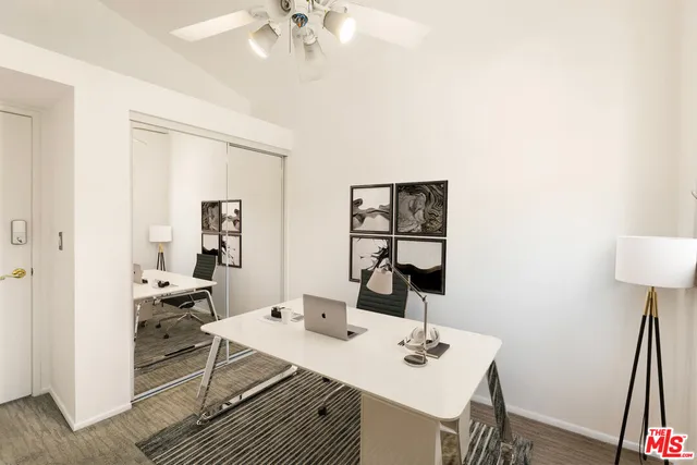 a view of a workspace with furniture and a bathroom