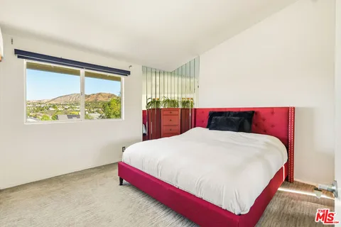 a bedroom with a bed and window