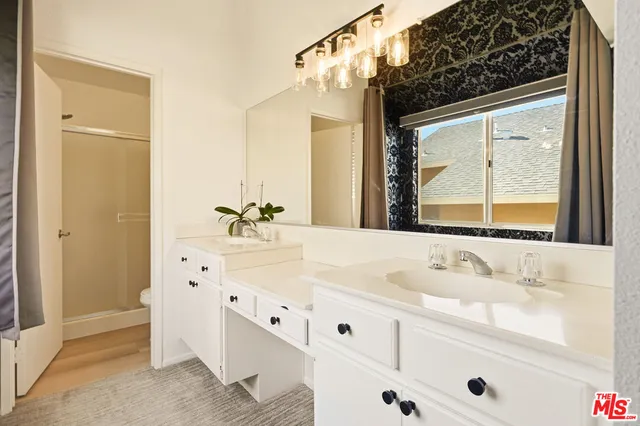 a bathroom with a sink vanity and a mirror