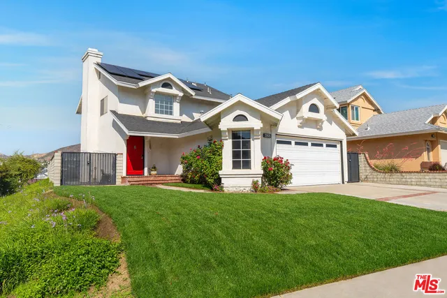 aerial view of multiple houses with yard